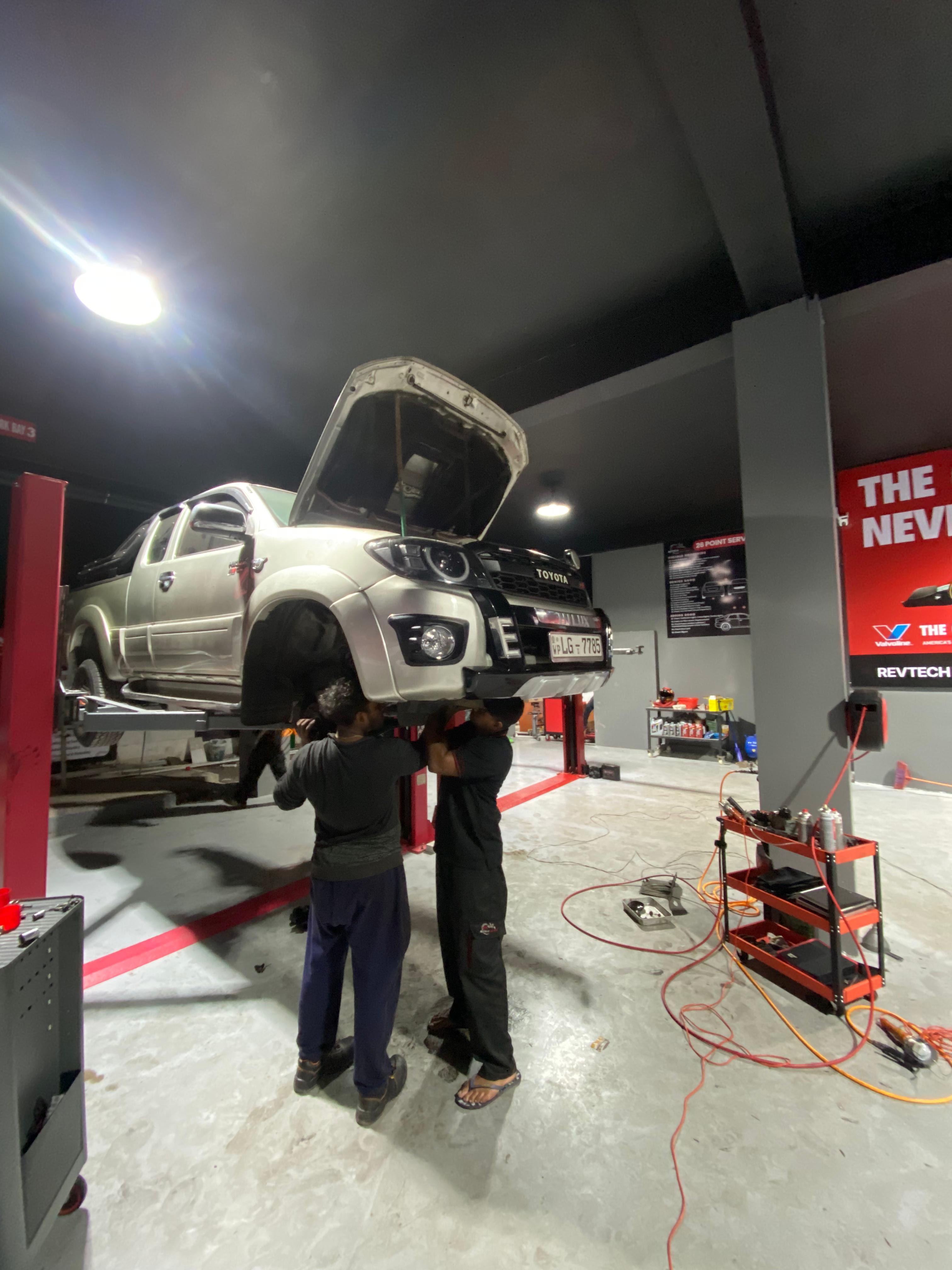 Vehicle on lift inside REVTECH workshop