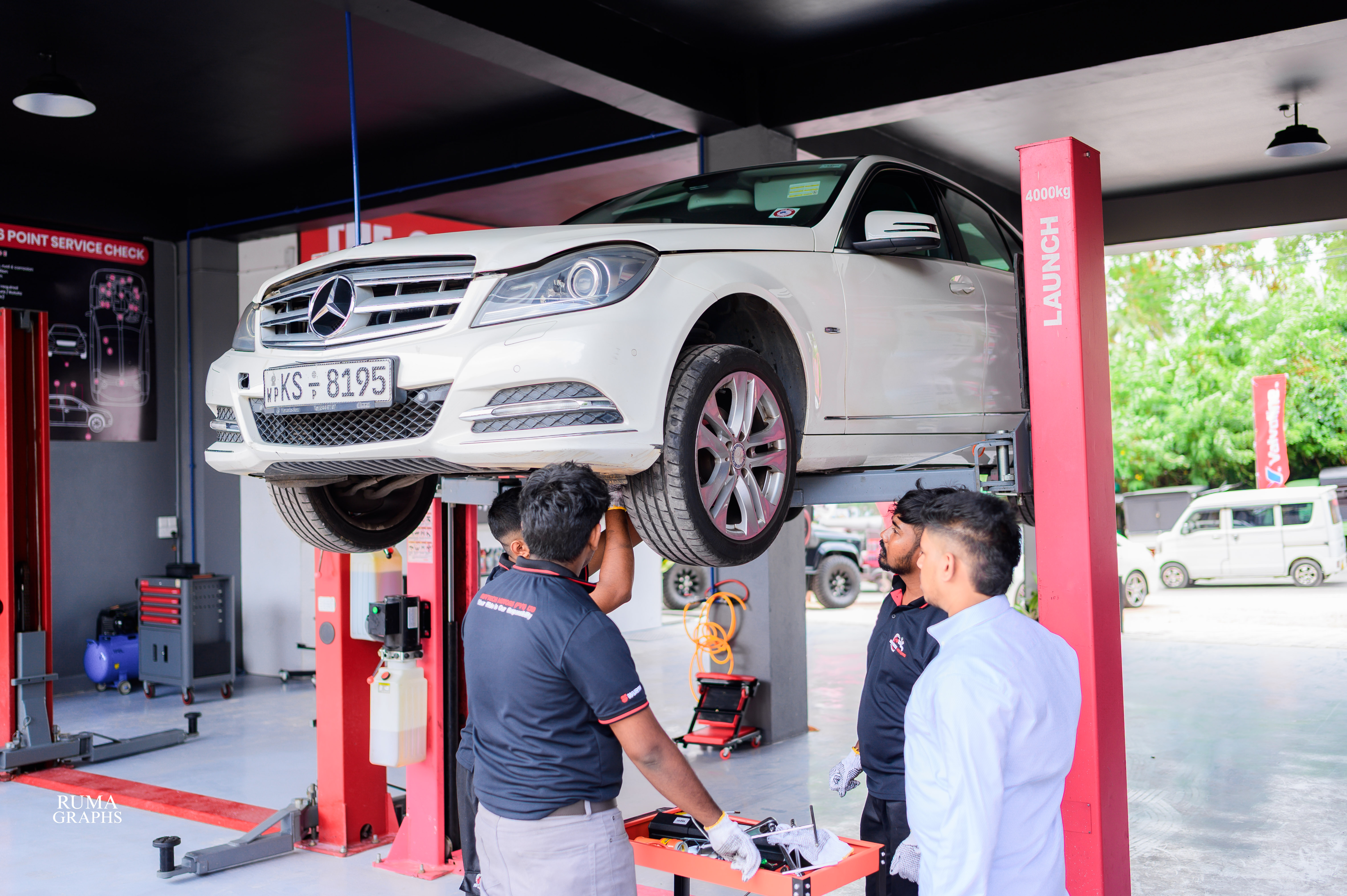 Mercedes vehicle on lift at REVTECH Motors